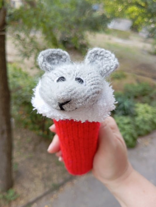 Knitted toy for a cat in the shape of a mouse wearing a Santa Claus hat